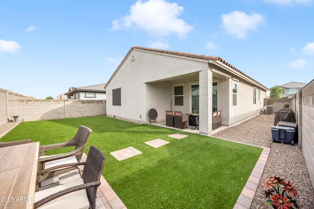 a view of backyard with outdoor seating and green space