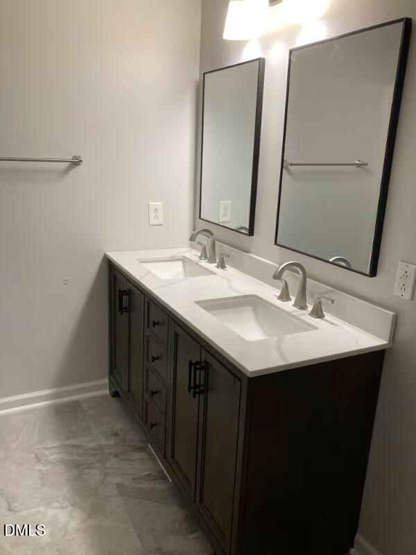 1505 Woodland Road Garner, NC 27529 - Photo 14 of 19 a bathroom with a sink and a mirror