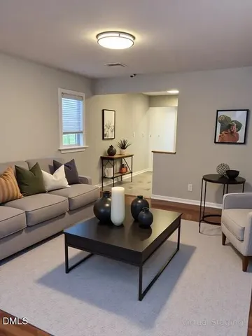 a living room with furniture and a night stand