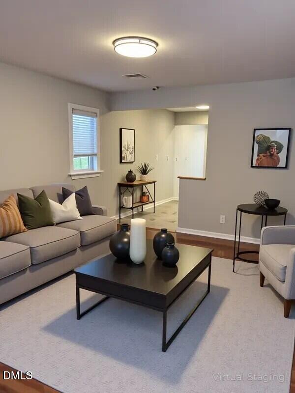 1505 Woodland Road Garner, NC 27529 - Photo 3 of 19 a living room with furniture and a night stand