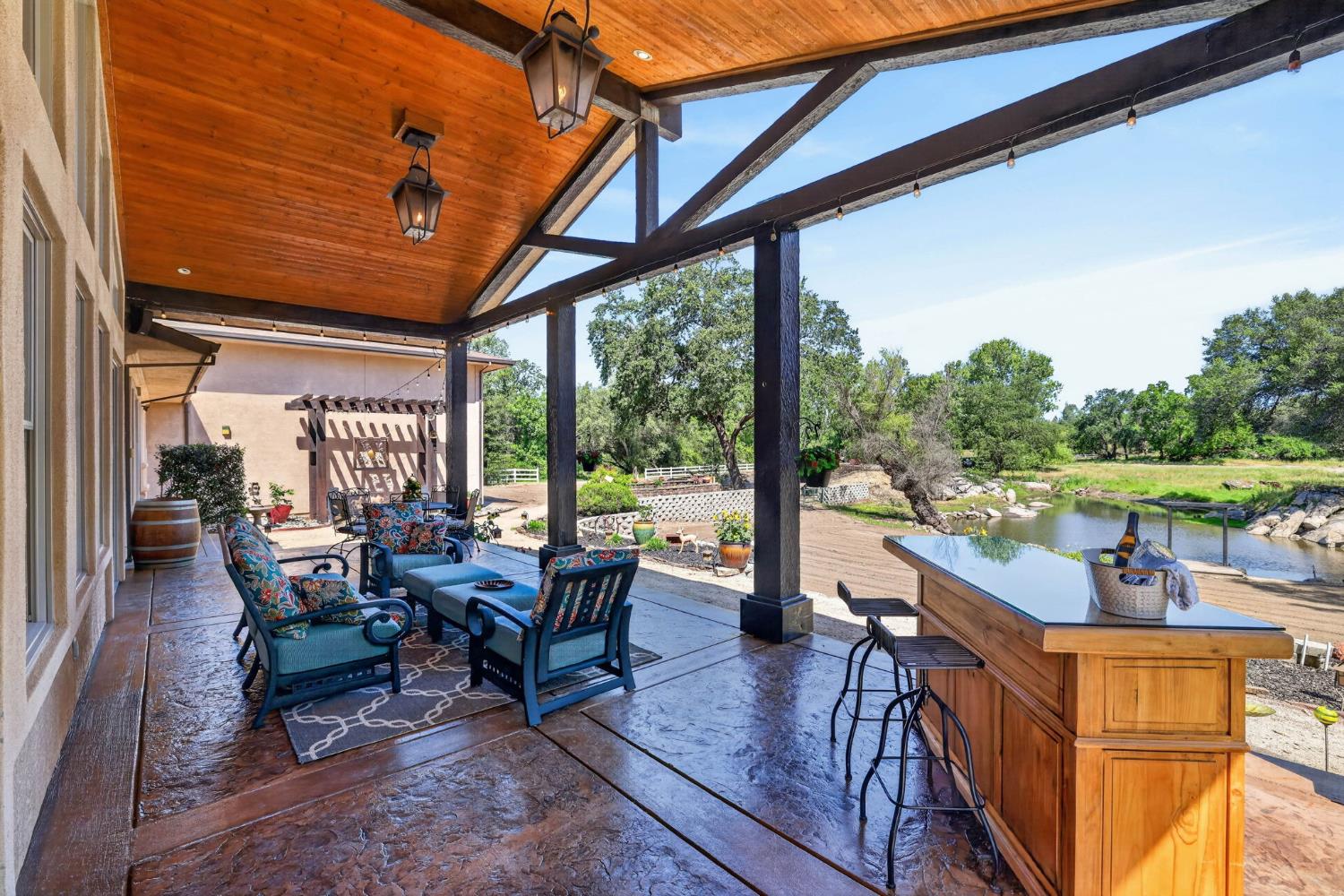 7021 Horseshoe Bar Road Loomis, CA 95650 - Photo 48 of 77 Vaulted timber beams, propane lanterns, and peaceful water views create a private retreat behind the home.