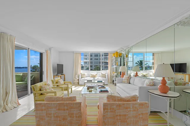 a living room with fireplace furniture and a large window