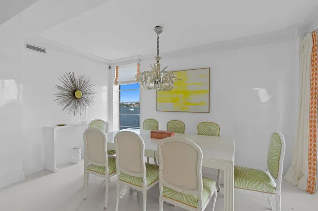 a dining room with furniture and a chandelier