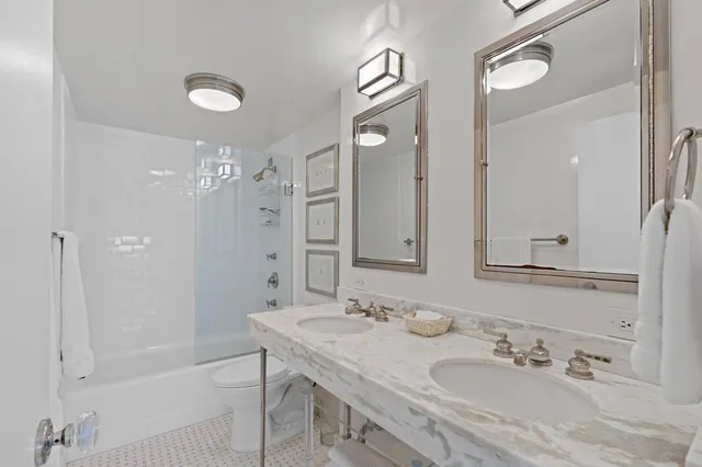 a bathroom with a granite countertop sink shower and a mirror