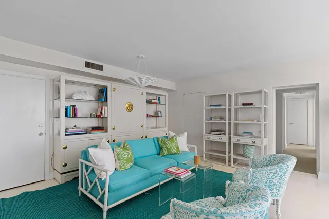 a living room with furniture and a book shelf