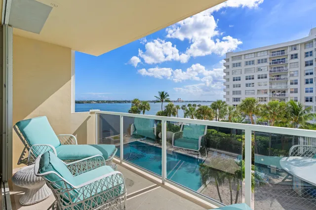 a view of a chairs and table in the balcony