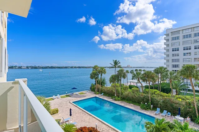 a view of a backyard with plants and lake view