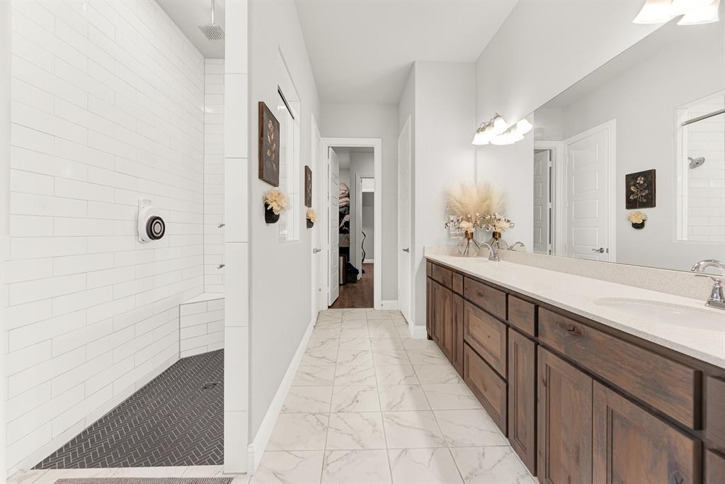 6404 Trezevant Street Rowlett, TX 75089 - Photo 20 of 30 a spacious bathroom with a double vanity sink a mirror and a shower