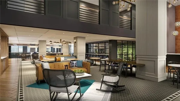 a living room with furniture and a floor to ceiling window