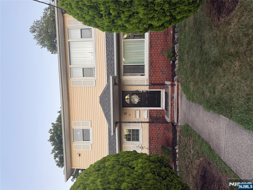 28 Boyd Street Lodi, NJ 07644 - Photo 1 of 7 a front view of a house with a garden and deck