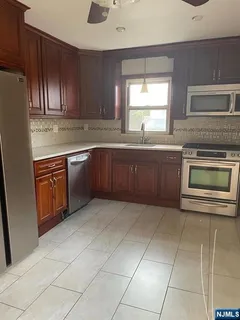 a kitchen with a sink a stove and cabinets