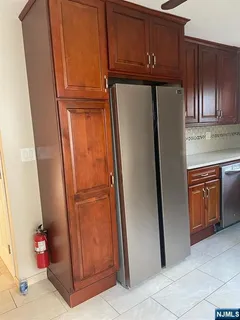 a kitchen with a refrigerator and cabinets