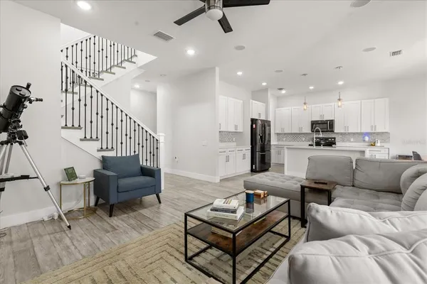 a living room with furniture and a potted plant