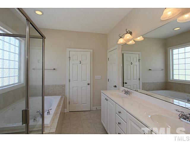 4701 All Points View Way Raleigh, NC 27614 - Photo 12 of 20 Spacious Master Bath features dual sink with large vanity which provides plenty of storage and counter-top space, separate shower, garden tub and large glass block window provides plenty of natural light.