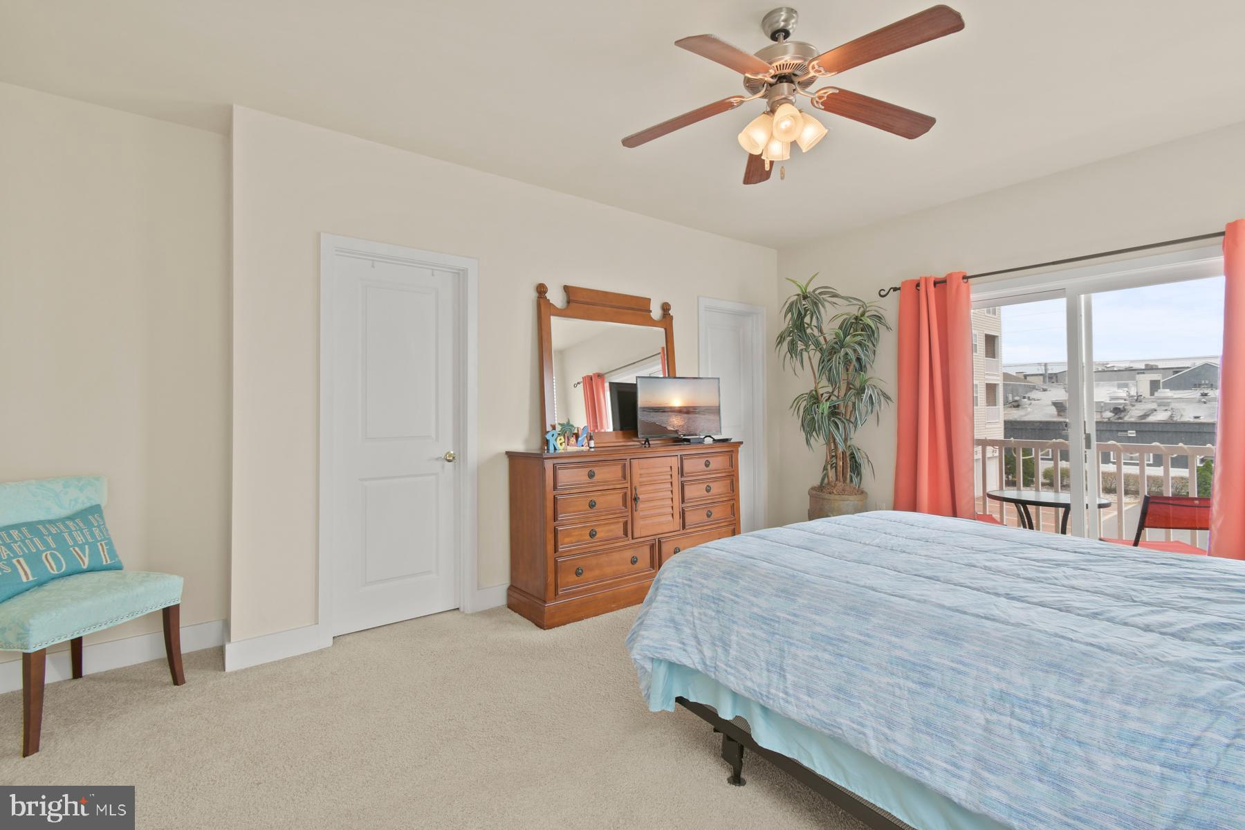 107 70th Street, Unit 10F Ocean City, MD 21842 - Photo 11 of 33 a bedroom with a bed and a chandelier