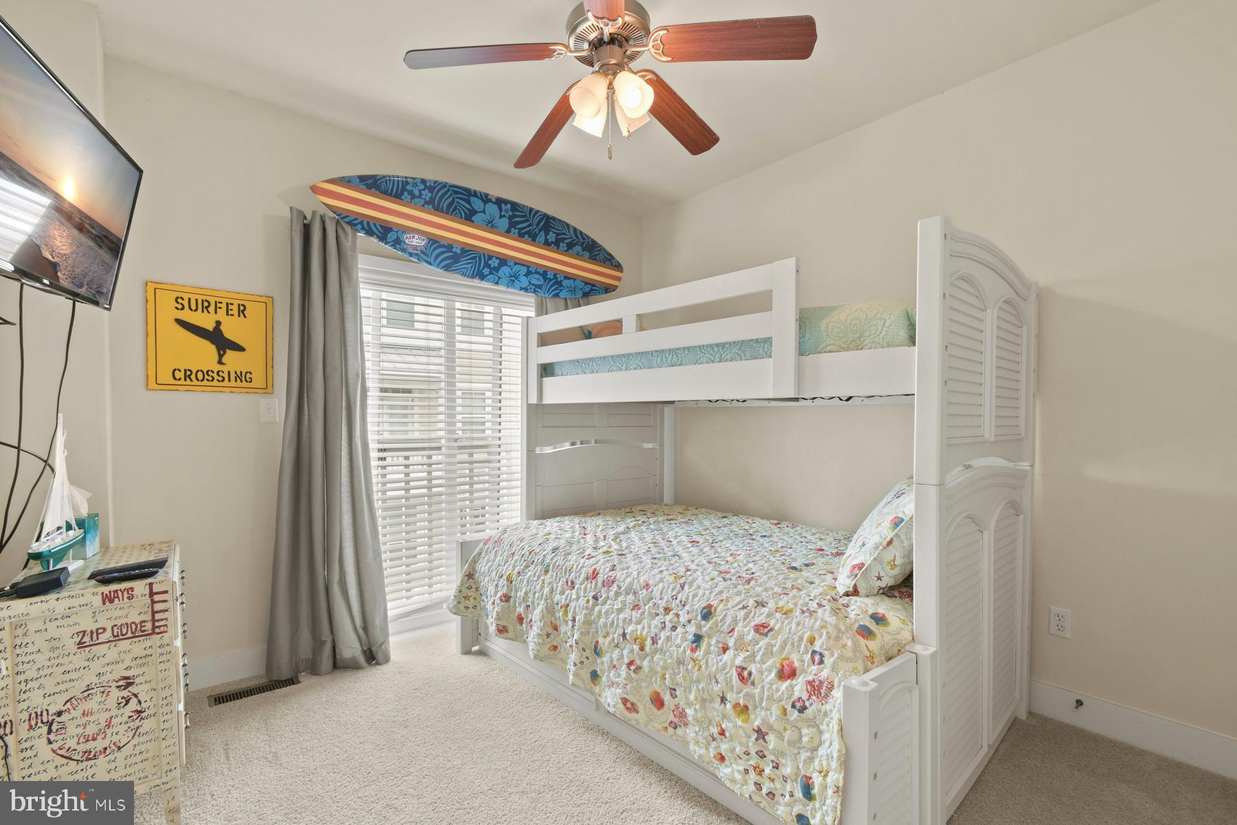 107 70th Street, Unit 10F Ocean City, MD 21842 - Photo 16 of 33 a bedroom with a bed and a window
