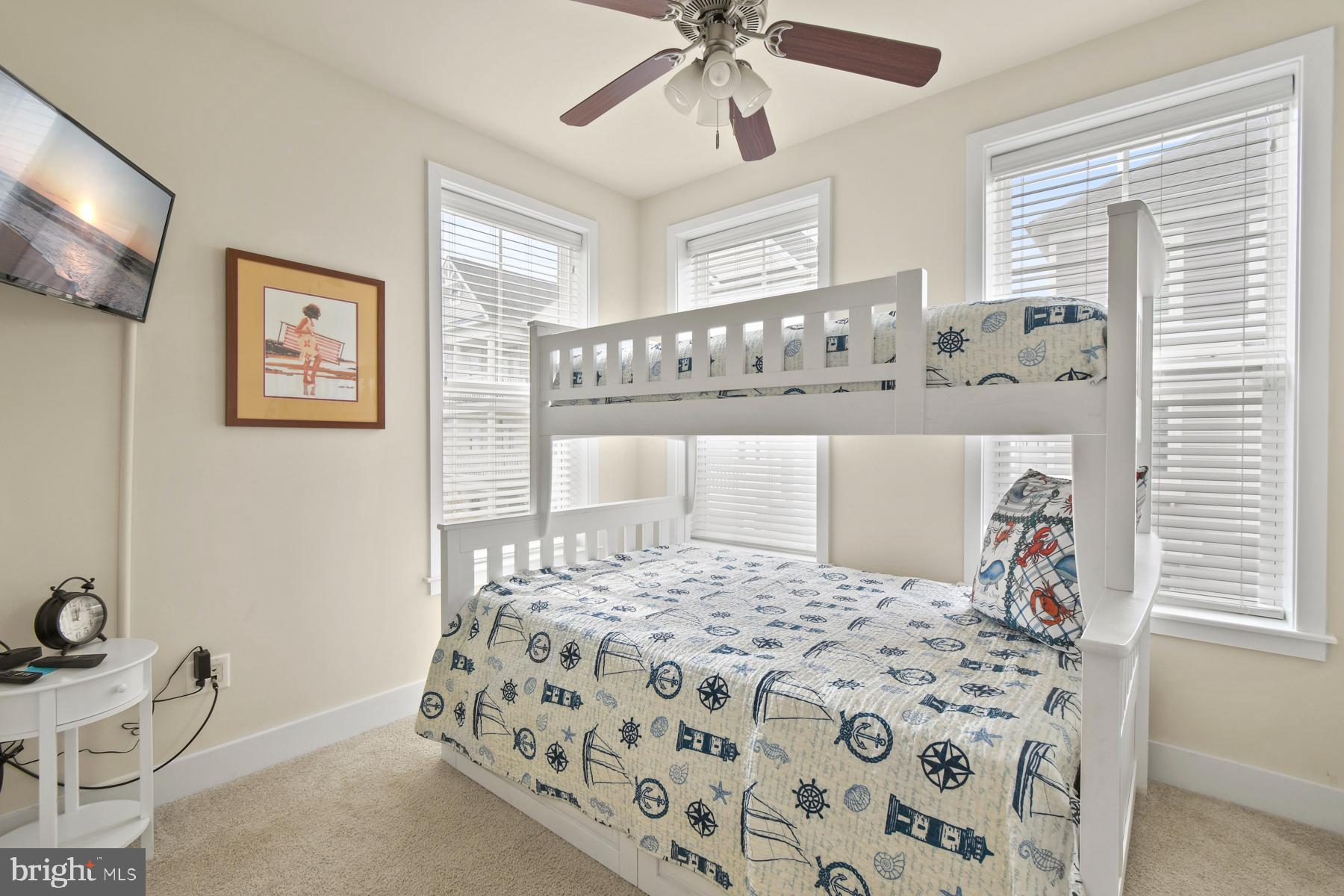 107 70th Street, Unit 10F Ocean City, MD 21842 - Photo 18 of 33 a bedroom with a large bed and a window