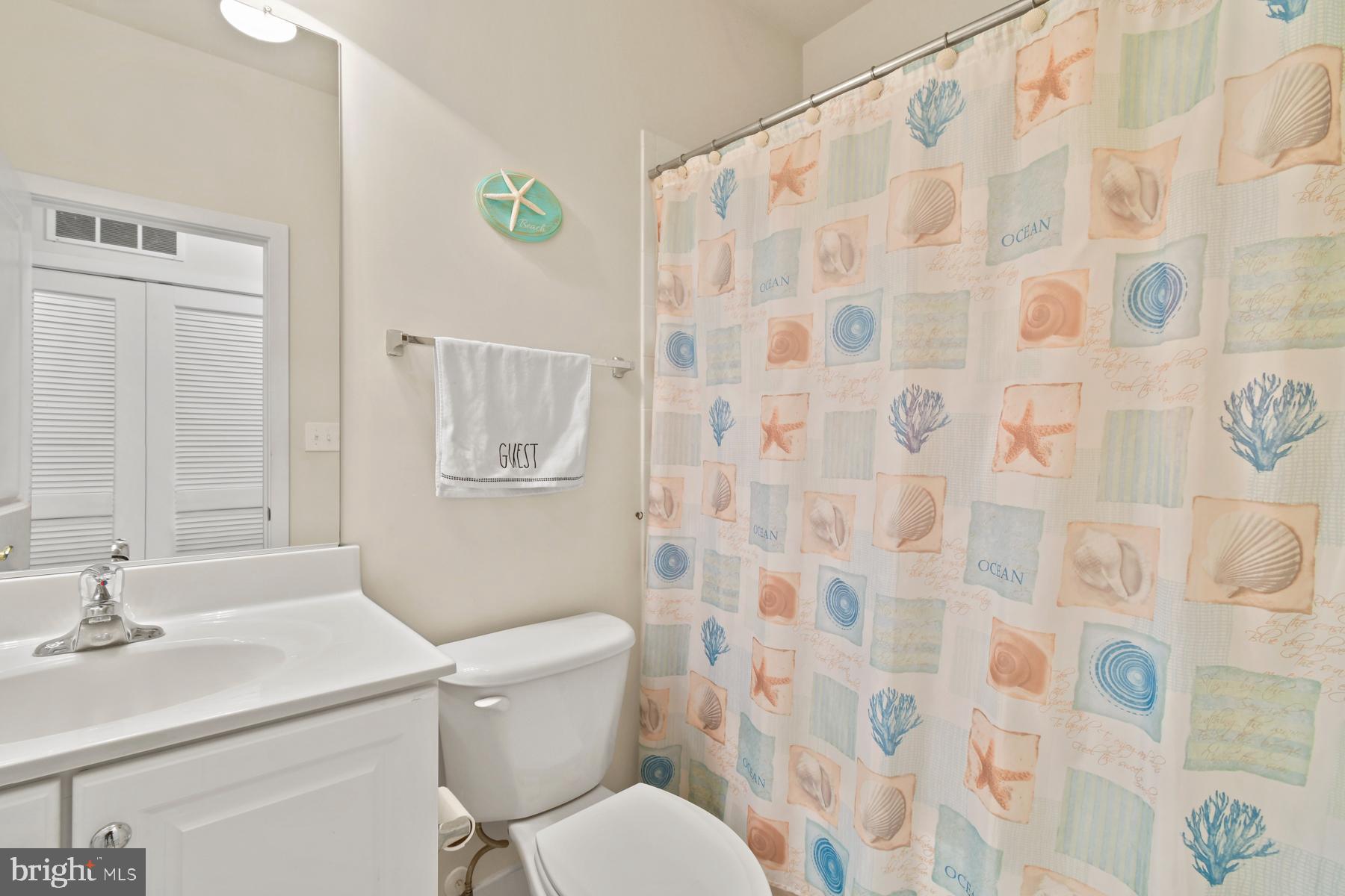 107 70th Street, Unit 10F Ocean City, MD 21842 - Photo 19 of 33 a bathroom with a sink toilet and a shower