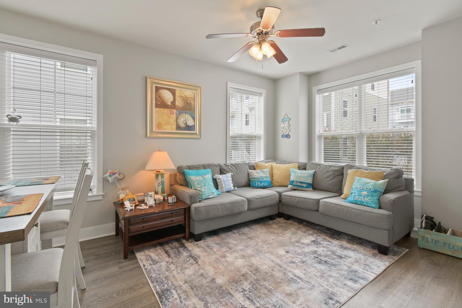 107 70th Street, Unit 10F Ocean City, MD 21842 - Photo 2 of 33 a living room with furniture and a large window