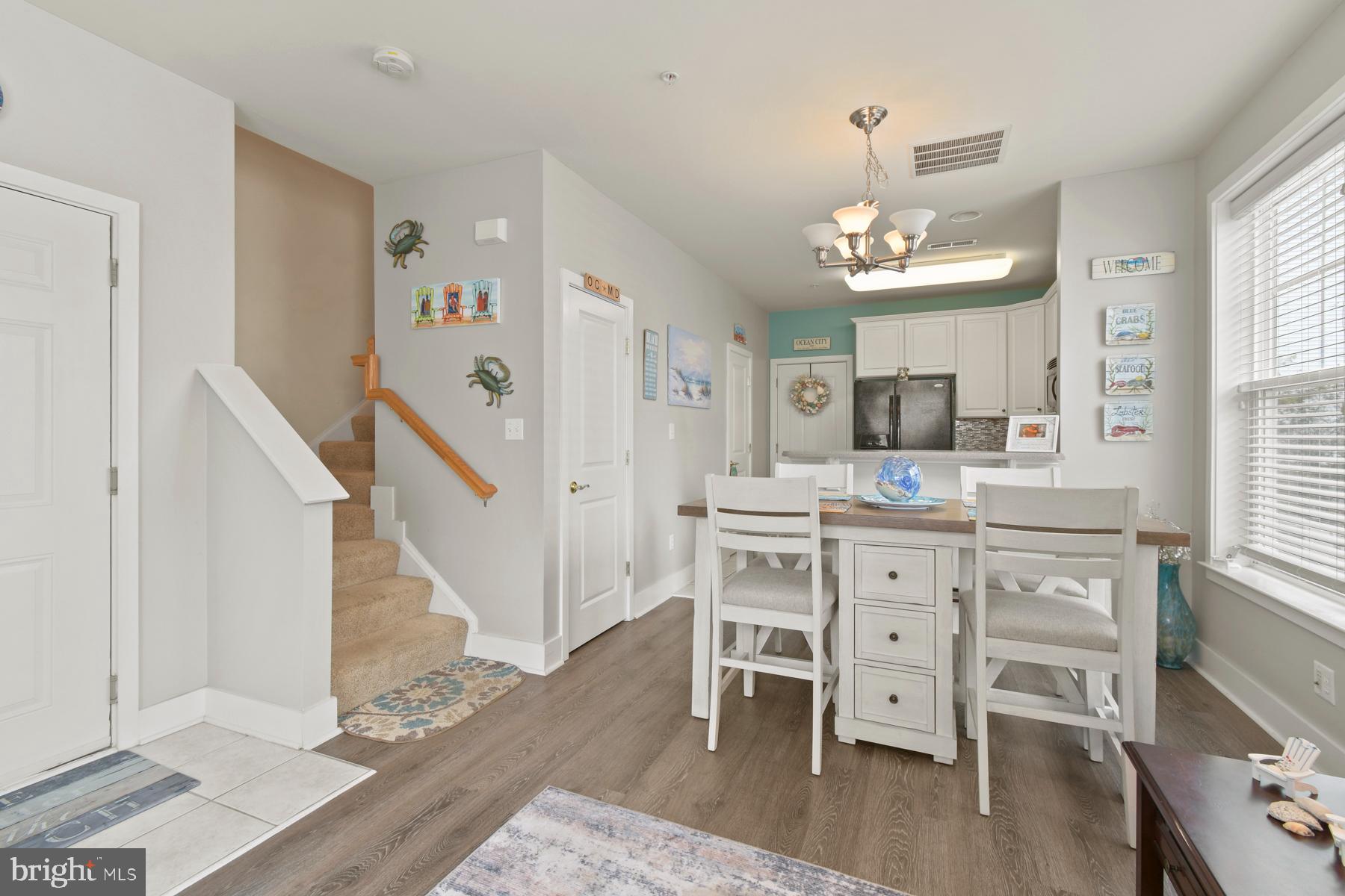 107 70th Street, Unit 10F Ocean City, MD 21842 - Photo 4 of 33 a view of dining room with furniture and wooden floor