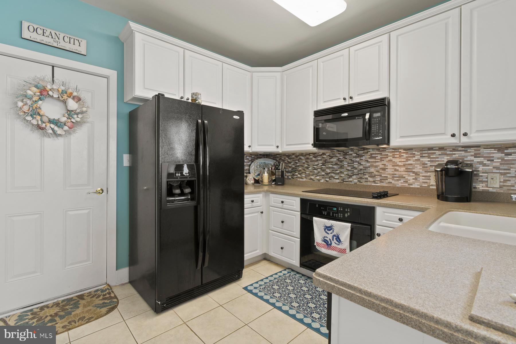107 70th Street, Unit 10F Ocean City, MD 21842 - Photo 6 of 33 a kitchen with stainless steel appliances granite countertop a refrigerator stove and sink