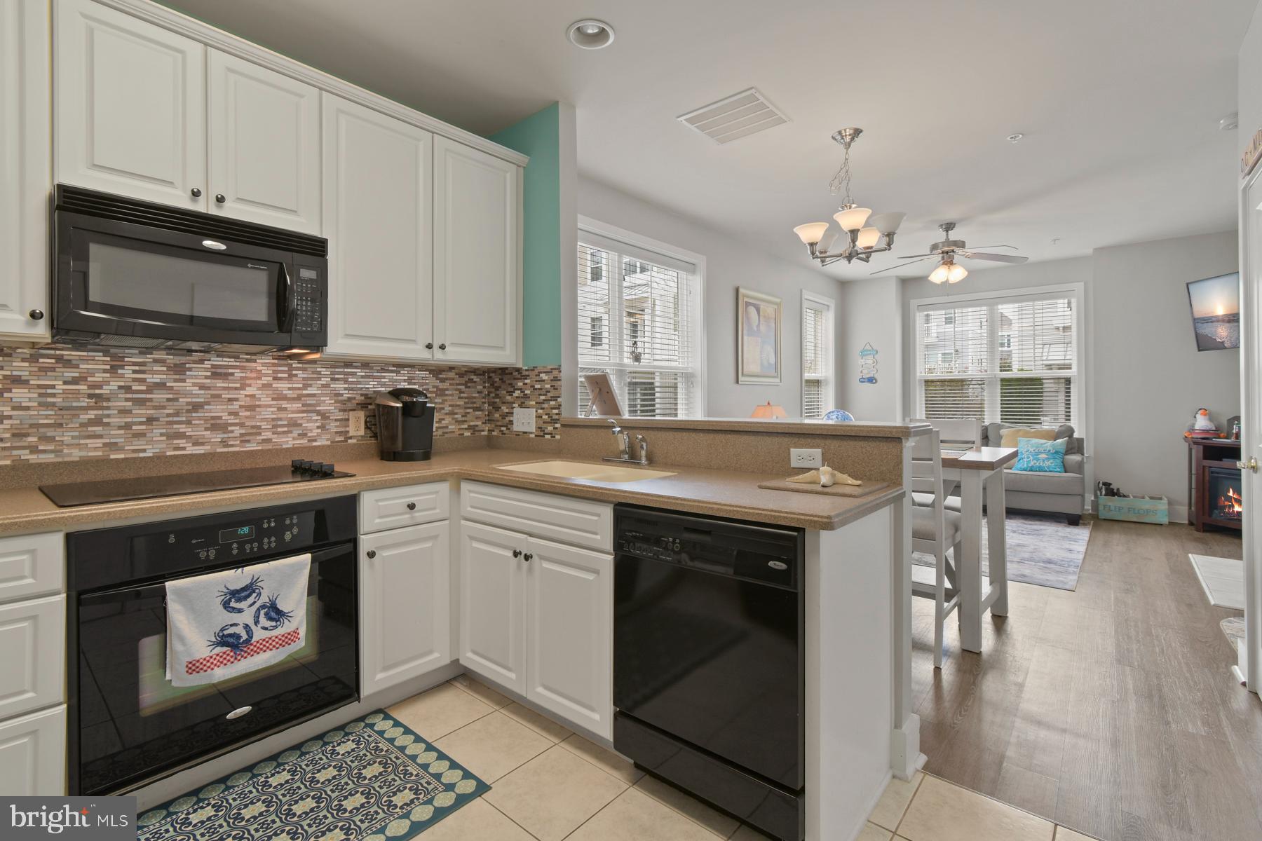 107 70th Street, Unit 10F Ocean City, MD 21842 - Photo 8 of 33 a kitchen with stainless steel appliances granite countertop a stove and a sink