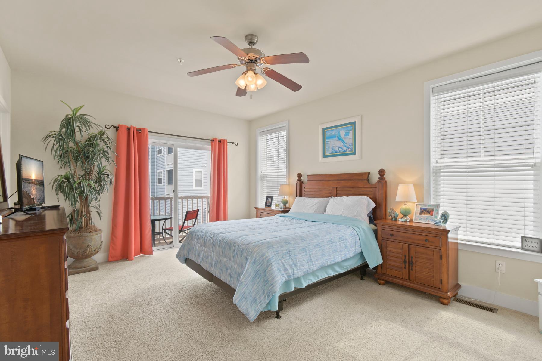 107 70th Street, Unit 10F Ocean City, MD 21842 - Photo 10 of 33 a bedroom with a large bed and a chandelier