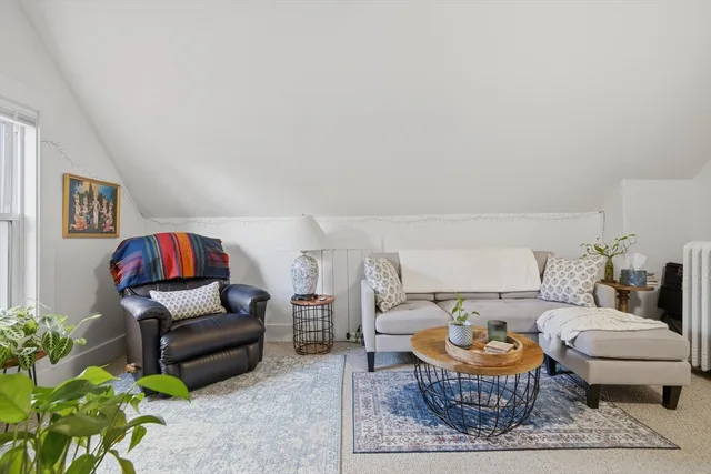 a living room with furniture and a rug