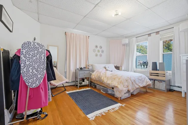 a spacious bedroom with a bed and a window