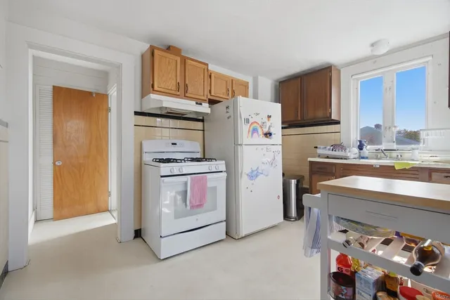 a kitchen with refrigerator and cabinets