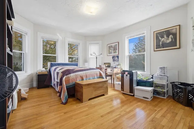 a bed room with a bed and a chair