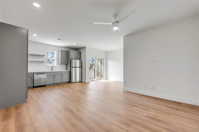 a view of a kitchen with a sink and a refrigerator