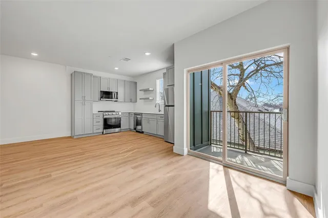 a view of a kitchen with wooden floor and a kitchen