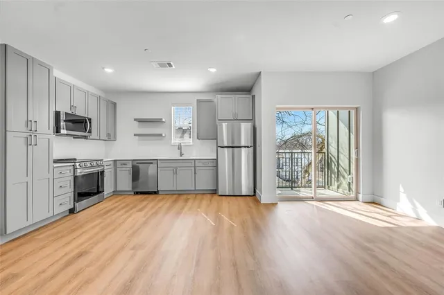 a large kitchen with cabinets and stainless steel appliances