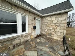 a view of a brick house with a large door