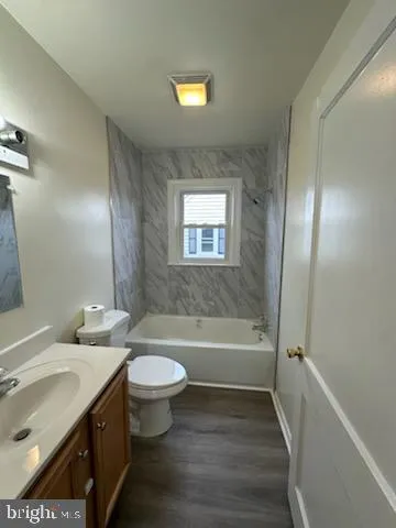 a bathroom with a double vanity sink toilet mirror and bathtub