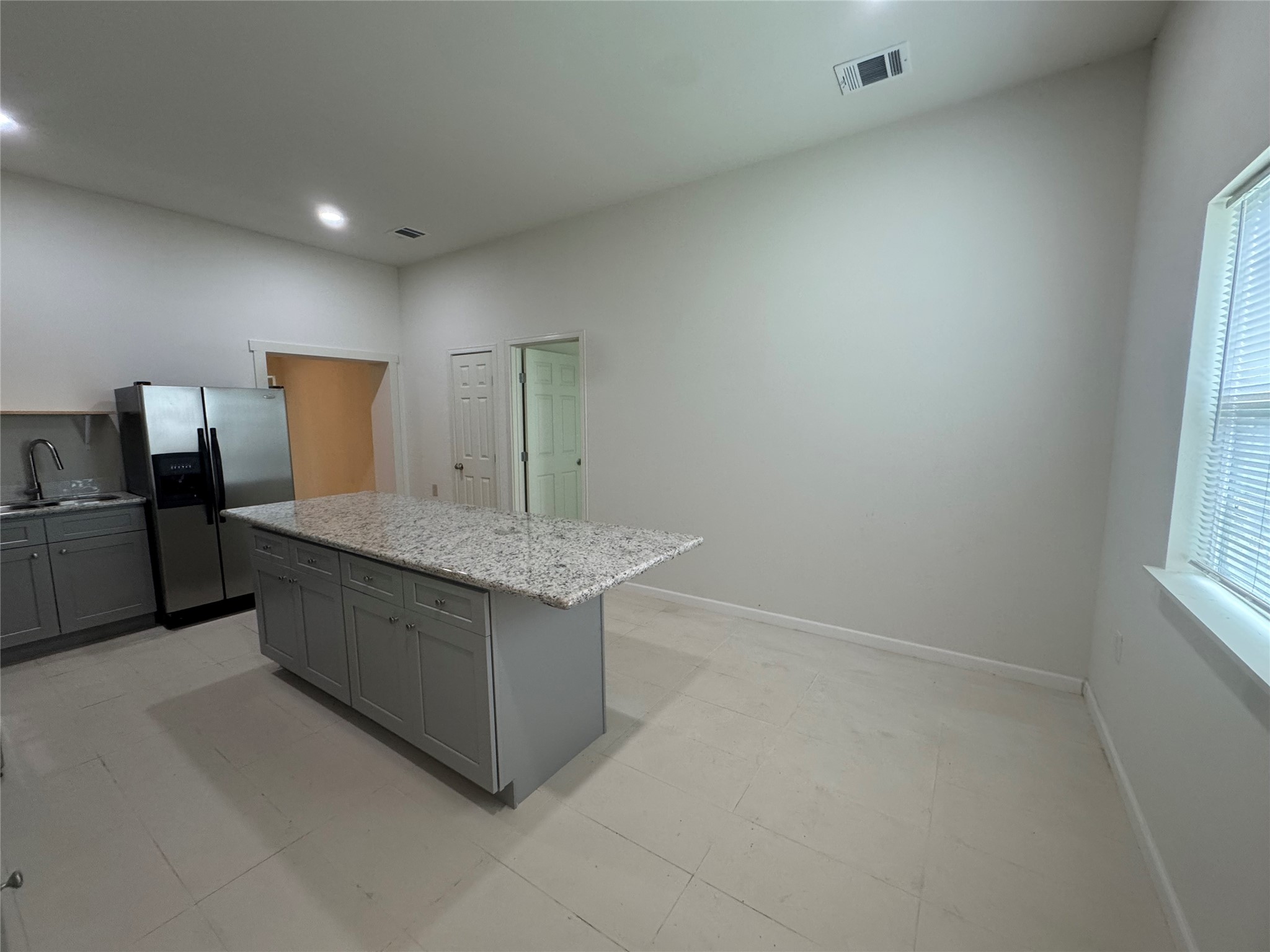 1443 Willow Rock Road Houston, TX 77088 - Photo 12 of 27 a kitchen with granite countertop white cabinets and stainless steel appliances
