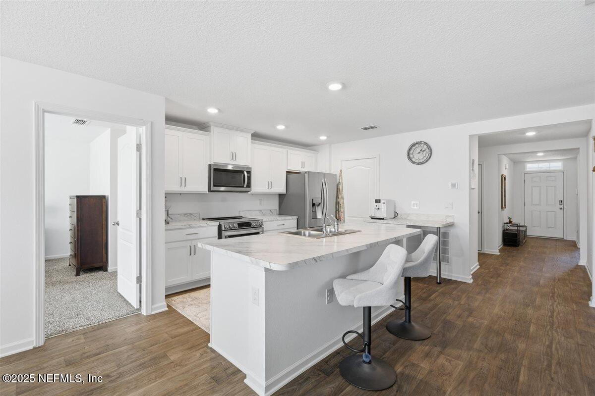 137 Tordera Ln Street St. Augustine, FL 32084 - Photo 12 of 43 a view of kitchen with stainless steel appliances refrigerator stove microwave and cabinets