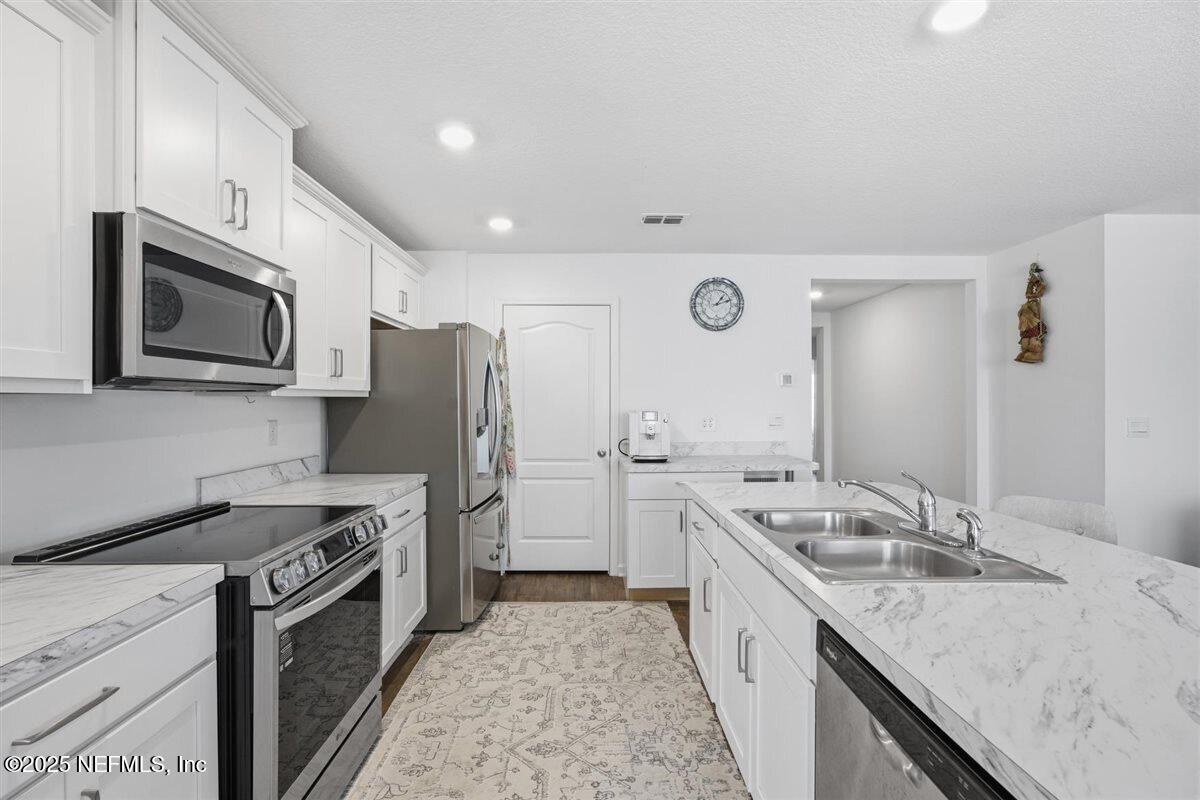 137 Tordera Ln Street St. Augustine, FL 32084 - Photo 14 of 43 a kitchen with a sink stove and refrigerator