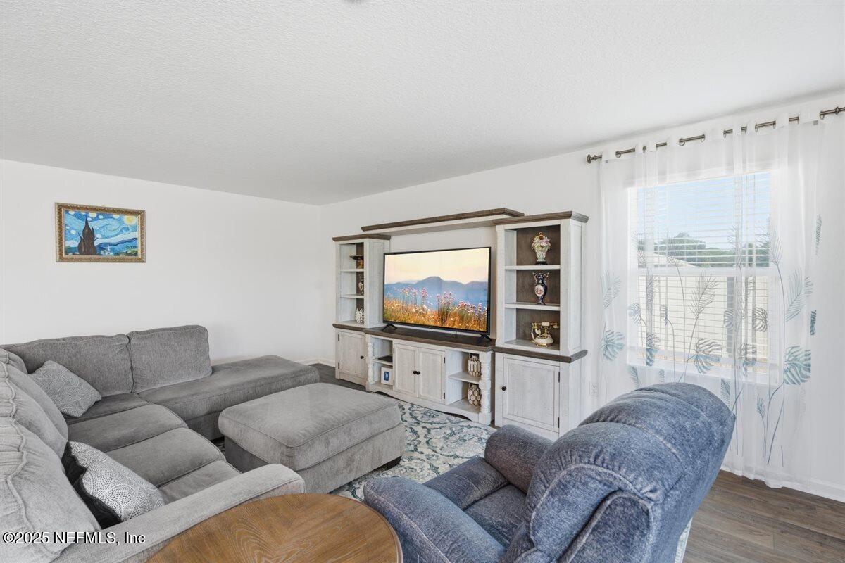 137 Tordera Ln Street St. Augustine, FL 32084 - Photo 16 of 43 a living room with furniture and a flat screen tv