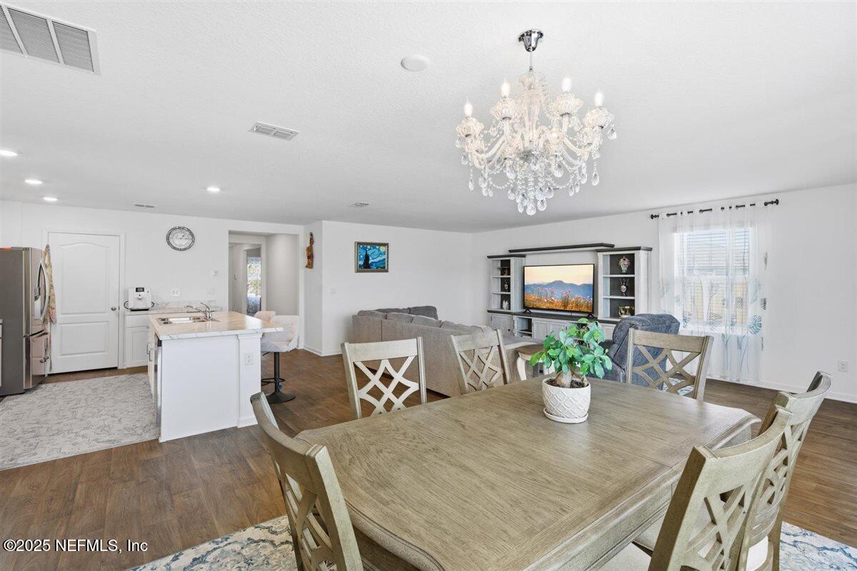 137 Tordera Ln Street St. Augustine, FL 32084 - Photo 18 of 43 a view of a dining room with furniture and chandelier