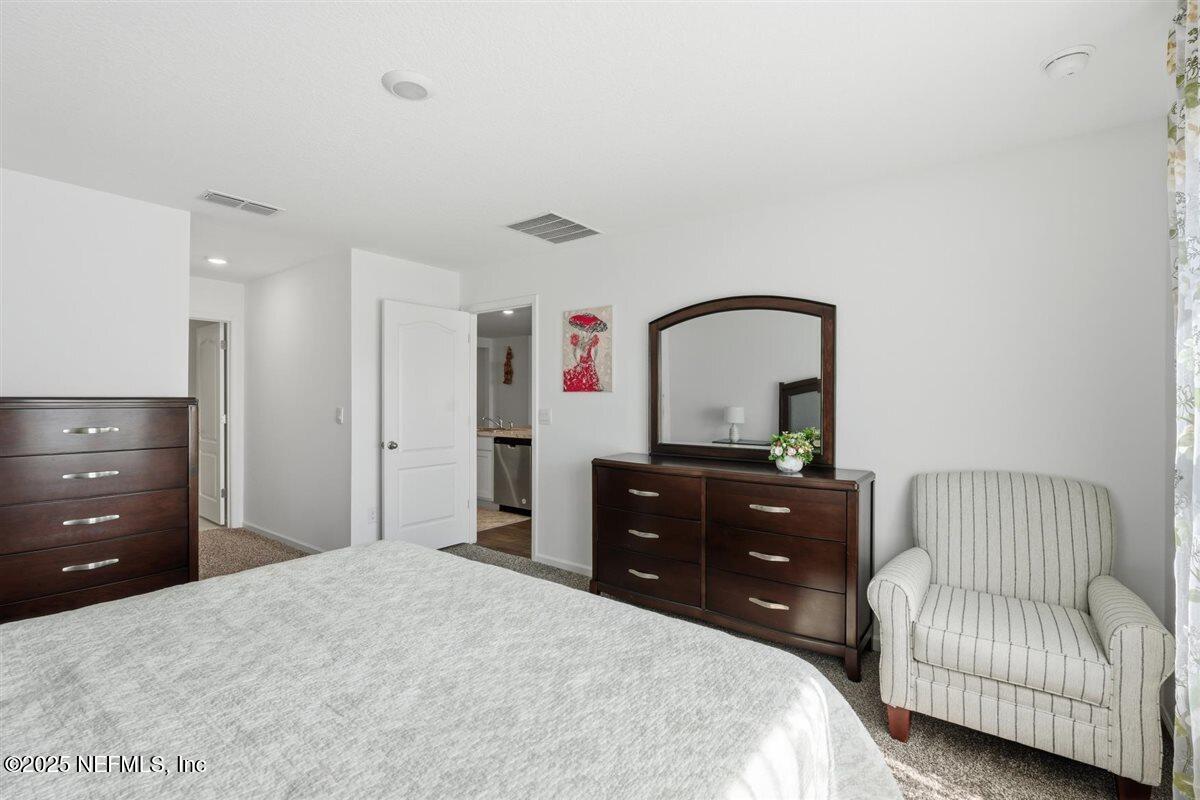 137 Tordera Ln Street St. Augustine, FL 32084 - Photo 22 of 43 a bedroom with a bed and a dresser