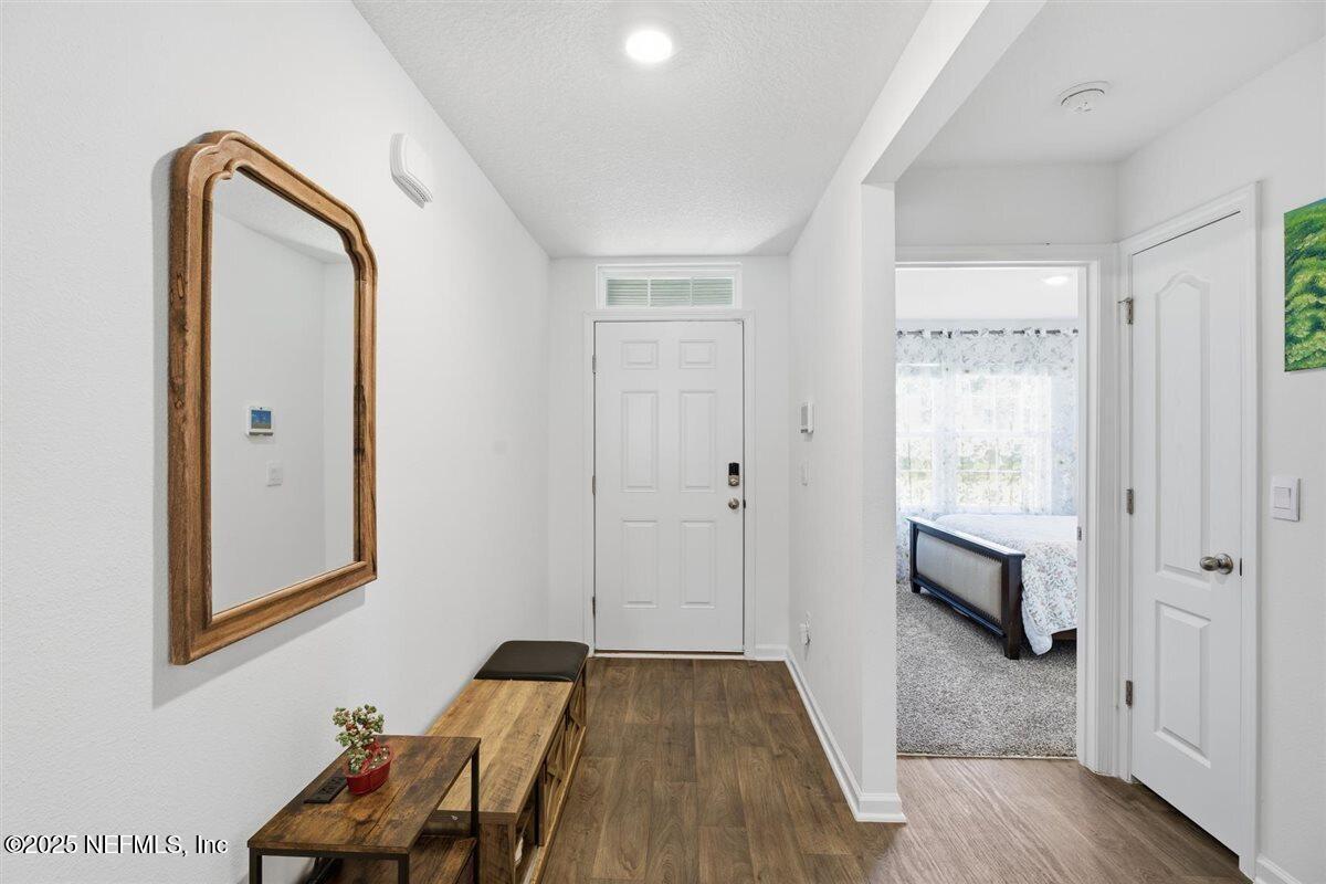 137 Tordera Ln Street St. Augustine, FL 32084 - Photo 4 of 43 a hallway with wooden floor chandelier and entryway