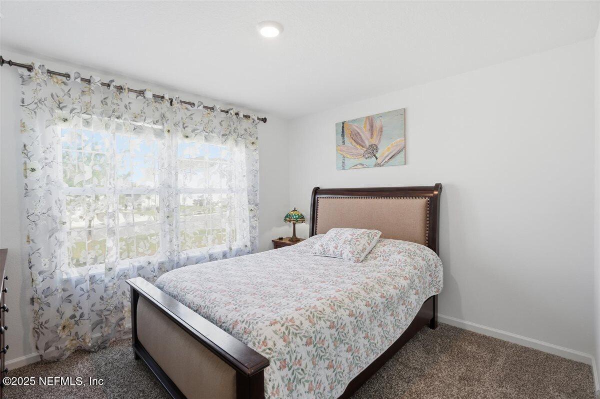 137 Tordera Ln Street St. Augustine, FL 32084 - Photo 5 of 43 a bedroom with a bed and a wall painting