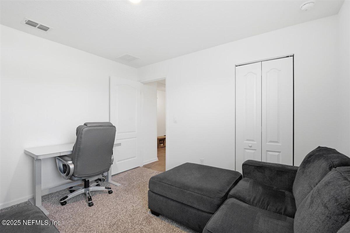 137 Tordera Ln Street St. Augustine, FL 32084 - Photo 9 of 43 a living room with a couch and a chair