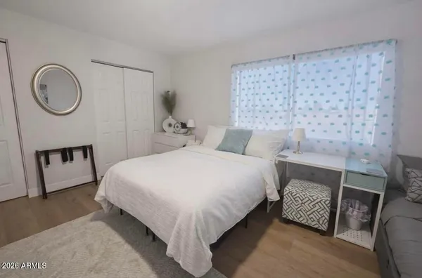 a bedroom with a bed mirror and a lamp