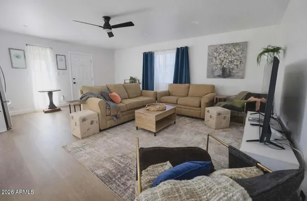 a living room with furniture and a flat screen tv