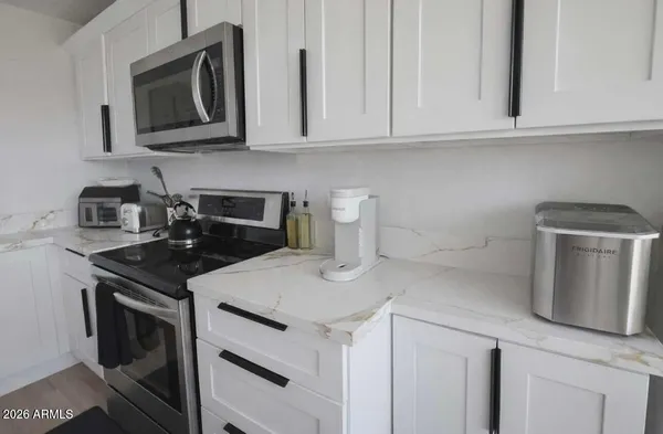 a kitchen with appliances a sink and cabinets