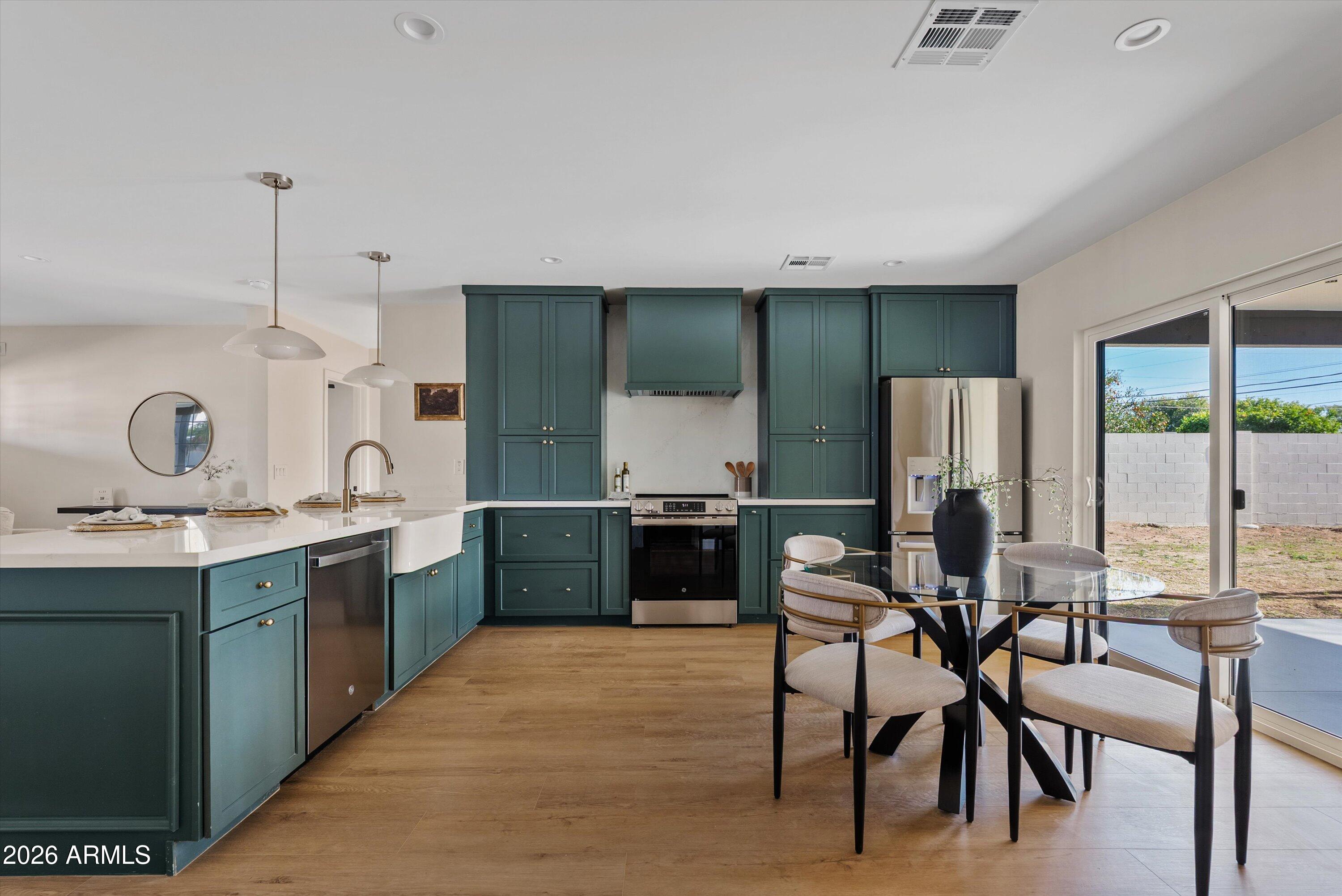 2941 East Cheery Lynn Road Phoenix, AZ 85016 - Photo 13 of 25 a open kitchen with stainless steel appliances kitchen island granite countertop a sink and cabinets