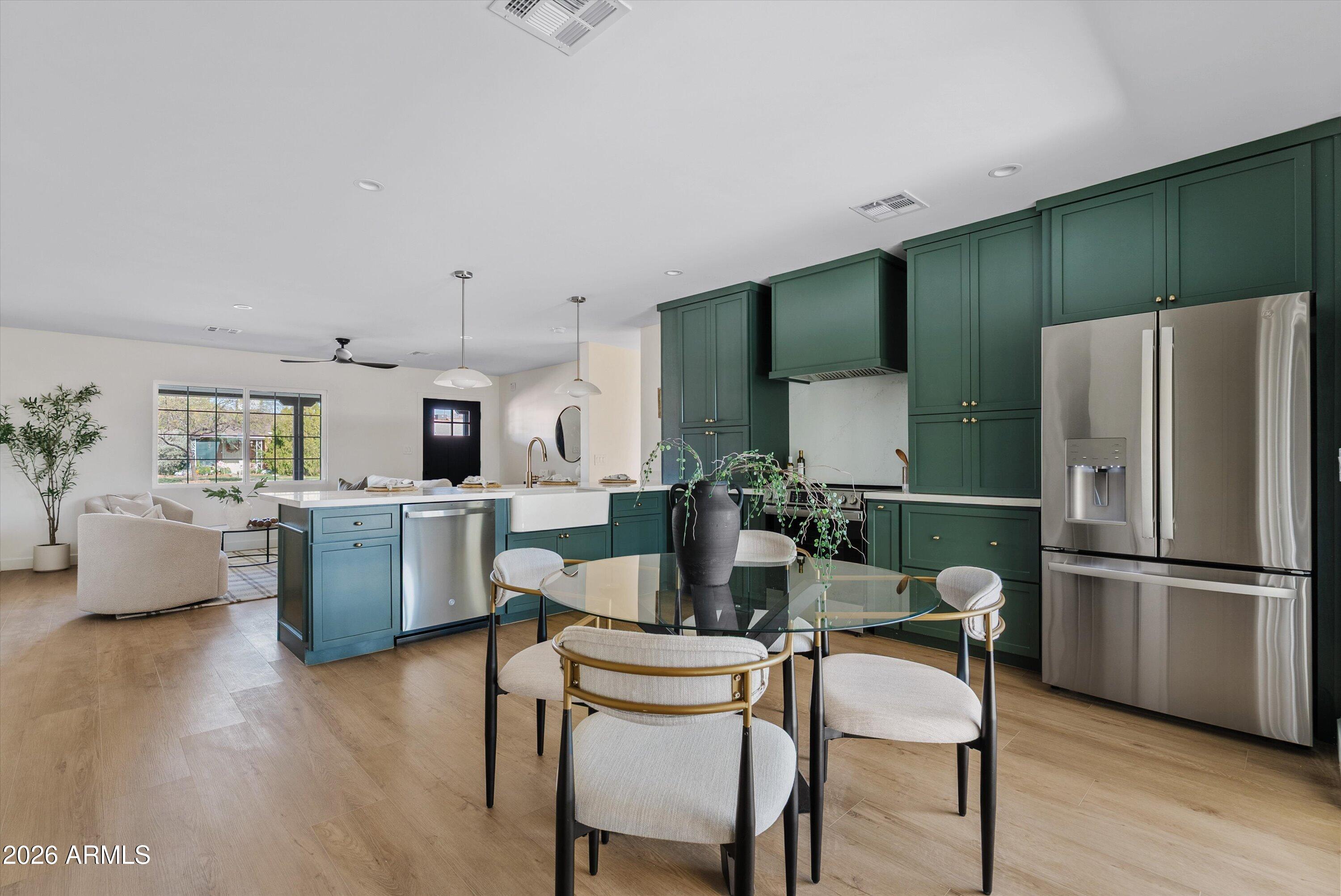 2941 East Cheery Lynn Road Phoenix, AZ 85016 - Photo 16 of 25 a kitchen with kitchen island white cabinets and stainless steel appliances